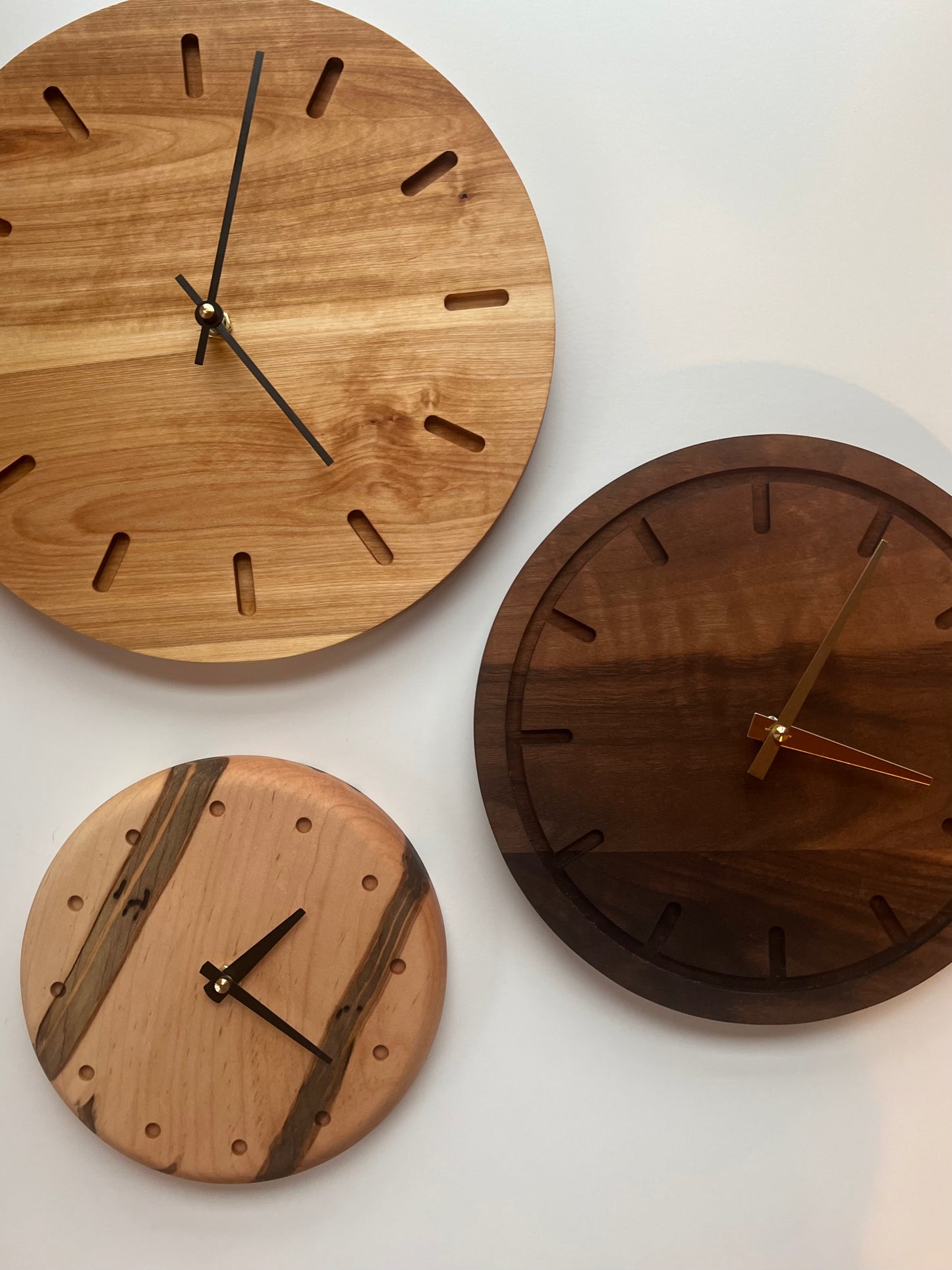 Modern, handmade dark wood wall clocks in light, dark and marbled wood variations made by Camino Woodshop in Milwaukee, WI that make amazing home decor or gifts
