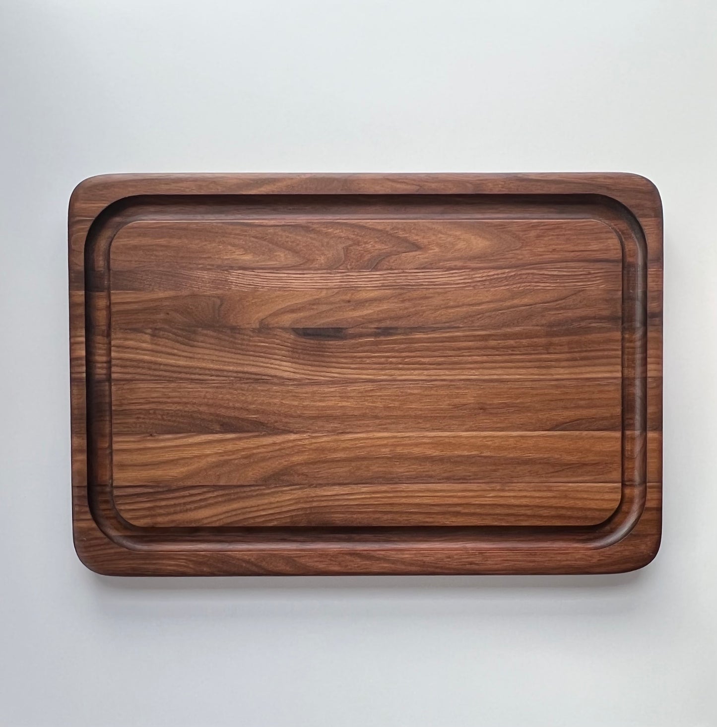 Beautiful, natural large, dark walnut wooden butcher block cutting board with juice groove