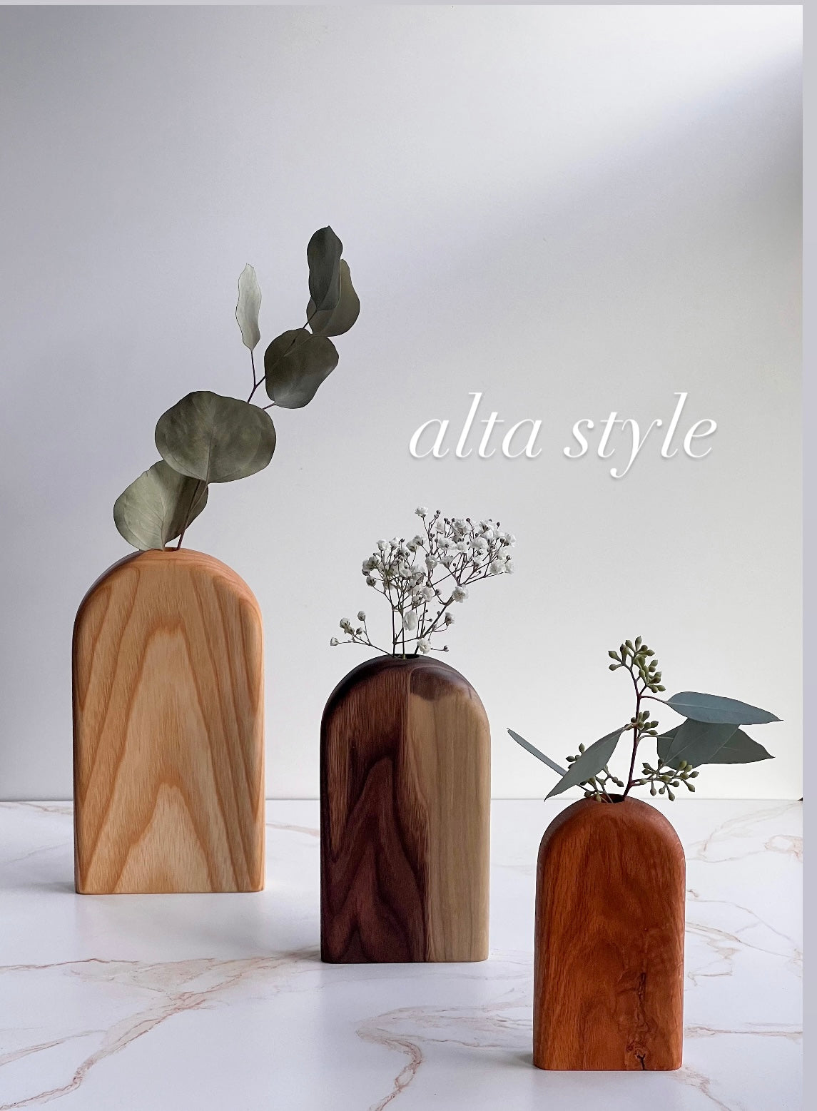 Organic bud/flower vases in all different variations of light and dark wood handmade by Camino Woodshop, making the perfect decor for your home or gift for friends and family