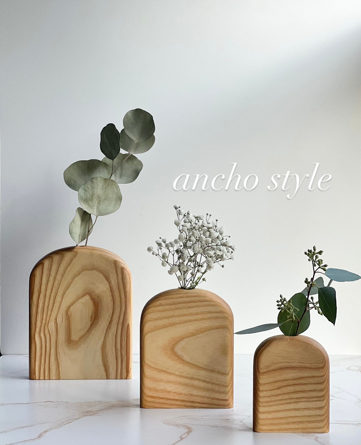 Rounded top organic bud/flower vases in all different variations of light and dark wood handmade by Camino Woodshop, making the perfect decor for your home or gift for friends and family