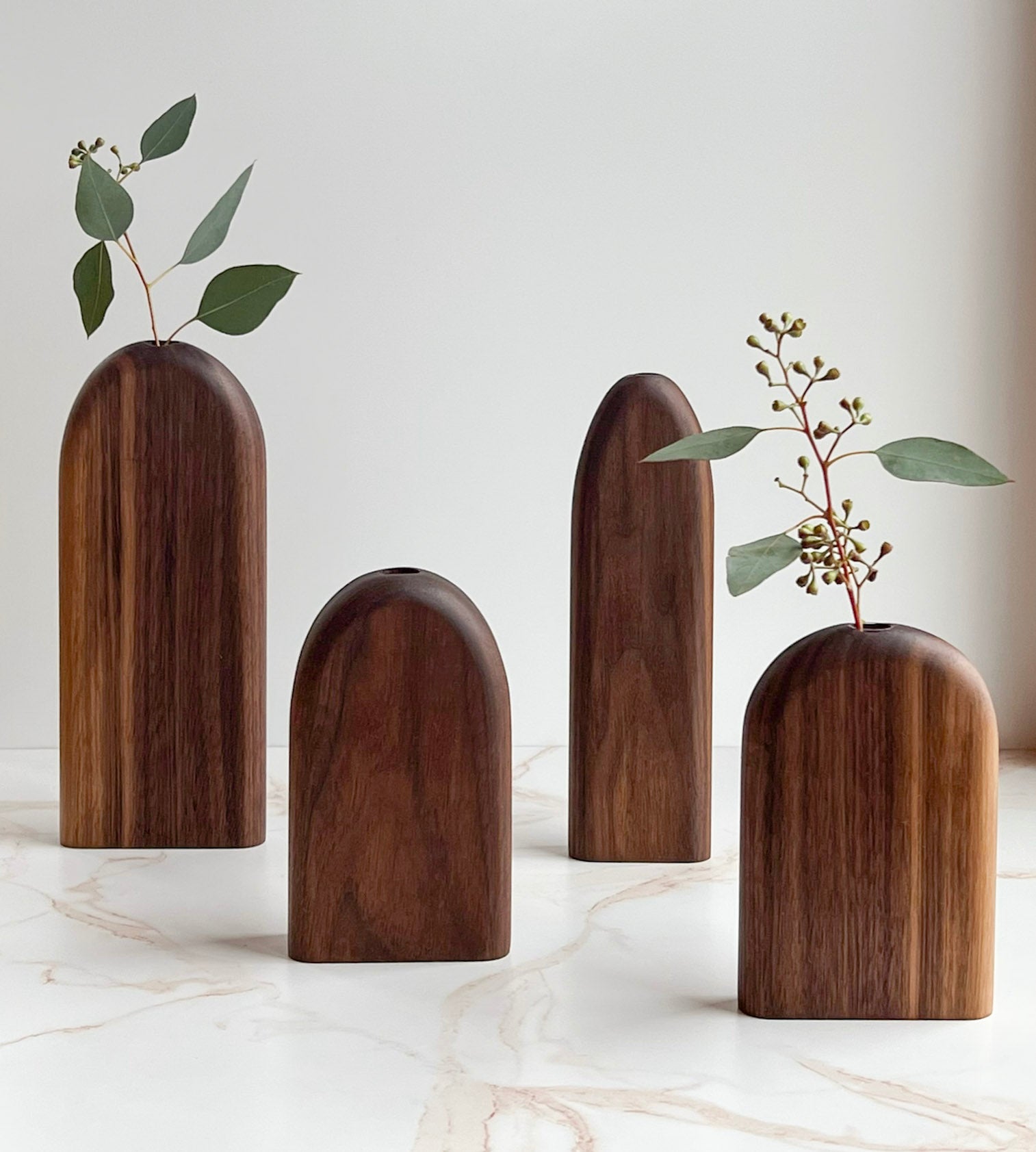 Rounded top, long and skinny and short and wide organic wooden bud/flower vases handmade by Camino Woodshop in Milwaukee, WI