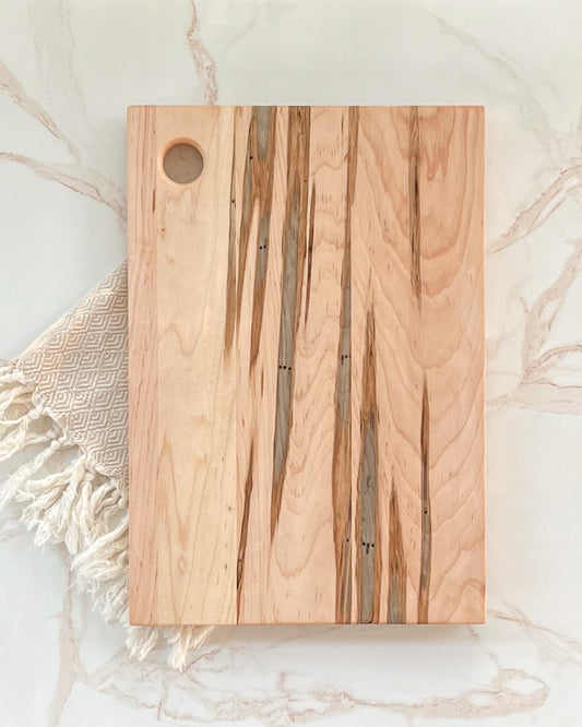 Simple no handle handcrafted wooden charcuterie and cutting board with dark wooden accents