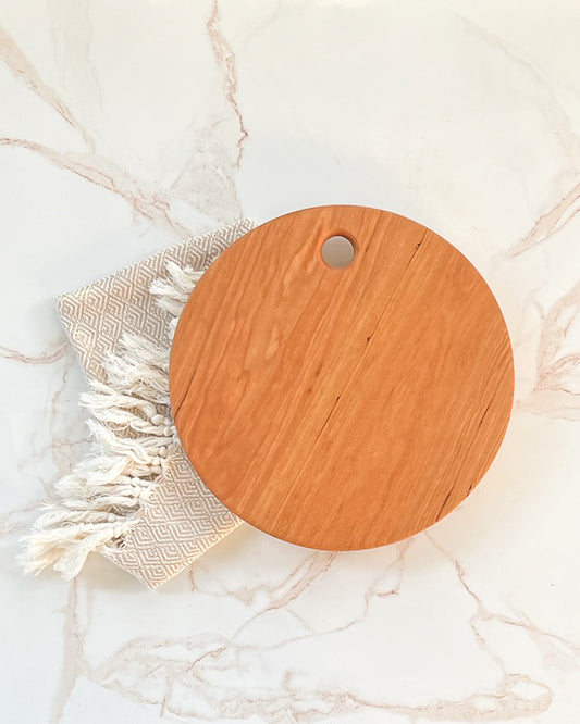 Simple no handle, circle handcrafted light wood charcuterie and cutting board
