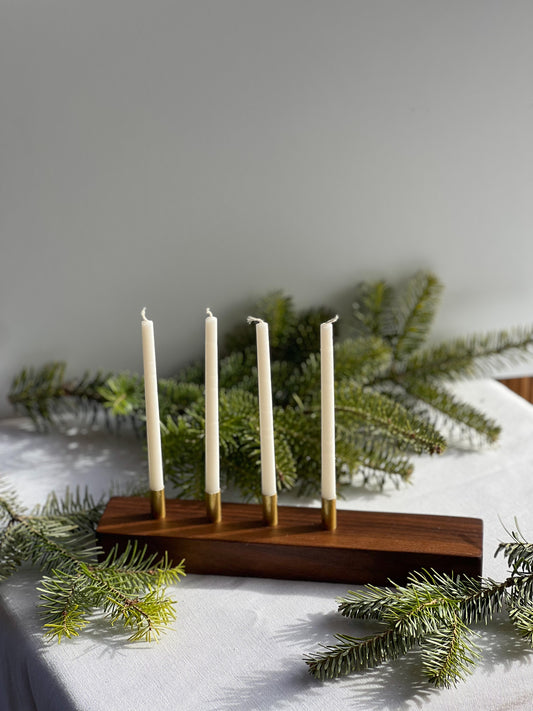 Gorgeous handmade wooden modern looking advent candle holder surrounded by pine needles making the perfect Christmas decoration for your home